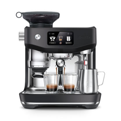 Breville Oracle Jet Black Truffle coffee machine with two glasses of coffee on a white background