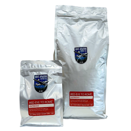 Two silver foil pouches of coffee from Loot Avatar Coffee Co. on a plain white background, one larger bag labeled Red Eye to Rome Espresso and one smaller matching pouch.