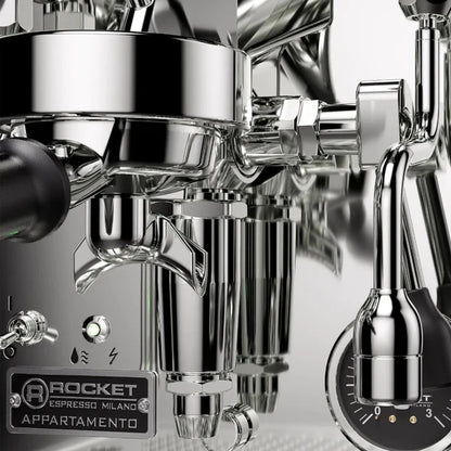 Rocket Appartamento TCA Chrome Black Details Close-up of a coffee machine with various attachments on a black background