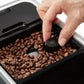 Bellucci Slim Latte bean grinder dial inside the hopper being adjusted by hand