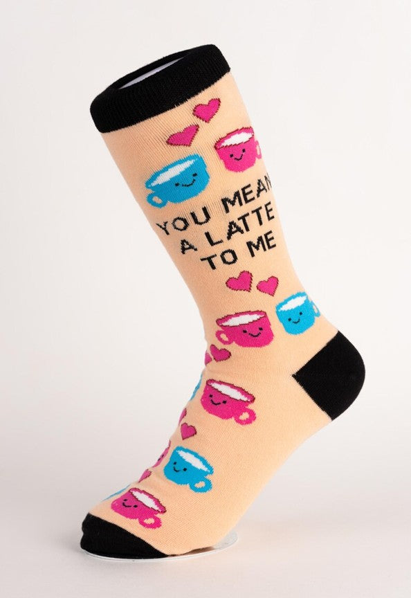 Sock with coffee cup and heart designs on a beige background