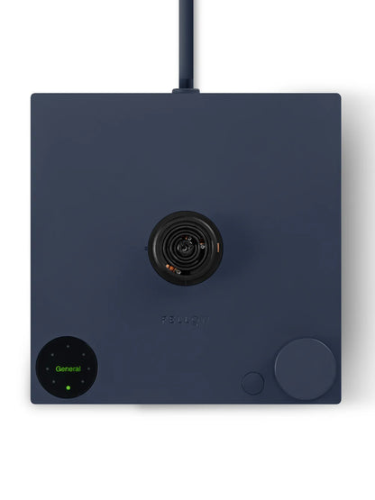 A dark navy blue square electronic device with a central black circular lens, a round green-lit control panel at the bottom left, and a large round dial at the bottom right, shown on a white background.