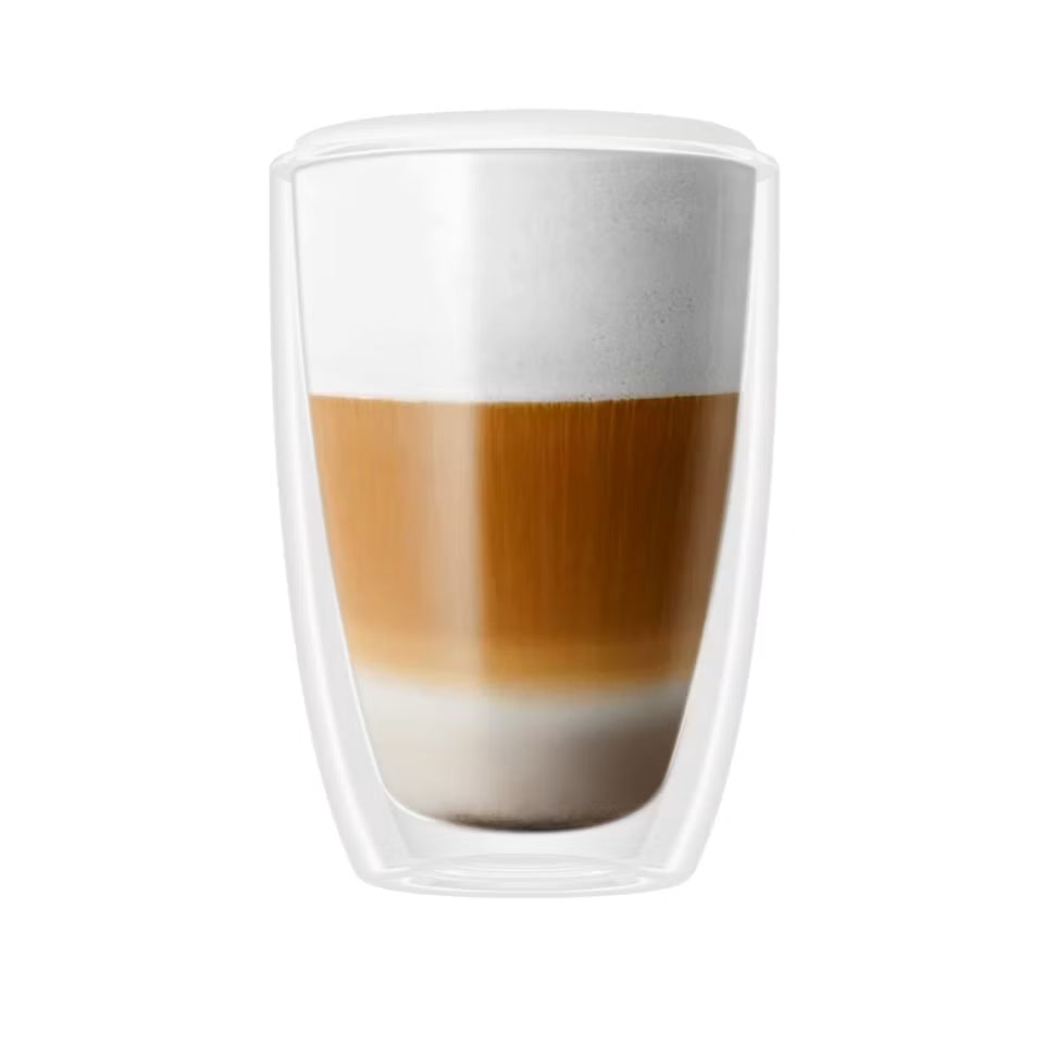 A double-walled clear glass cup containing a layered coffee drink with white foam on top, centered on a plain white background.
