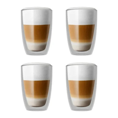 Four clear double-walled tumblers arranged in a 2x2 grid, each filled with a layered latte coffee design showing brown coffee and white foam on a white background.