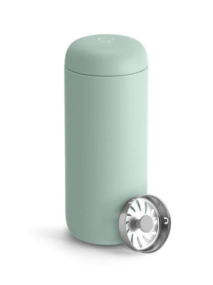 A mint green travel mug on a white background
