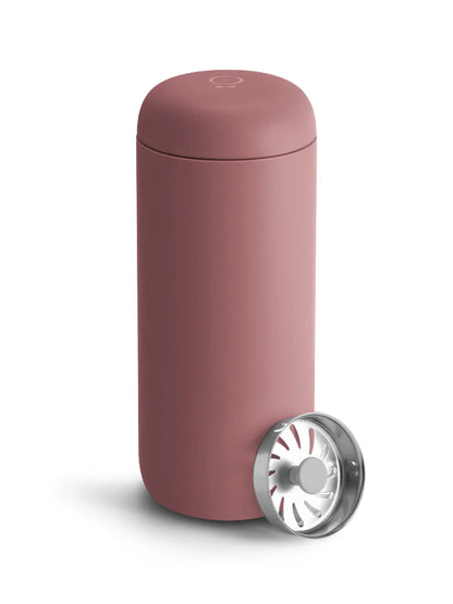 Pink travel mug with a silver base on a white background