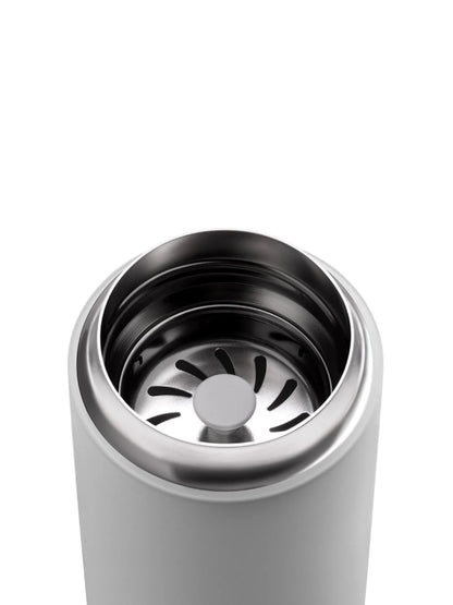 Close-up of a grey travel mug with a silver interior and metal splash guard on a white background