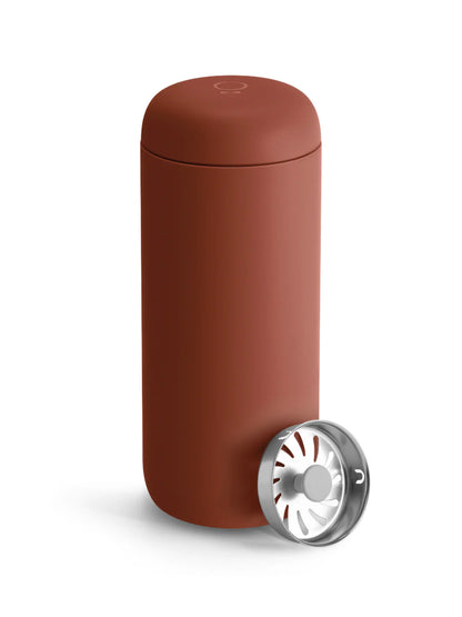 Brown travel mug with a silver splash accessory on a white background