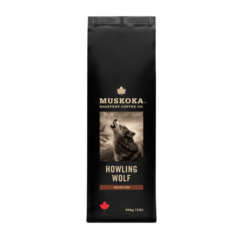 A 11lb bag of Muskoka Howling Wolf Medium Dark coffee in a matte black bag with a central graphic of a howling wolf and gold lettering.