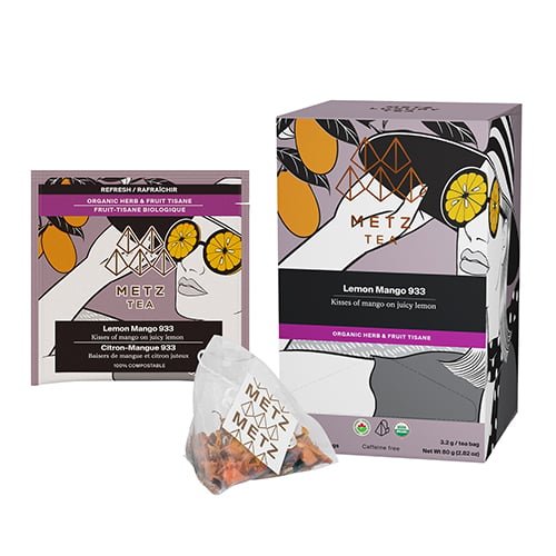 Box of tea with image of women wearing sunglasses with lemon, looking at a mango tree