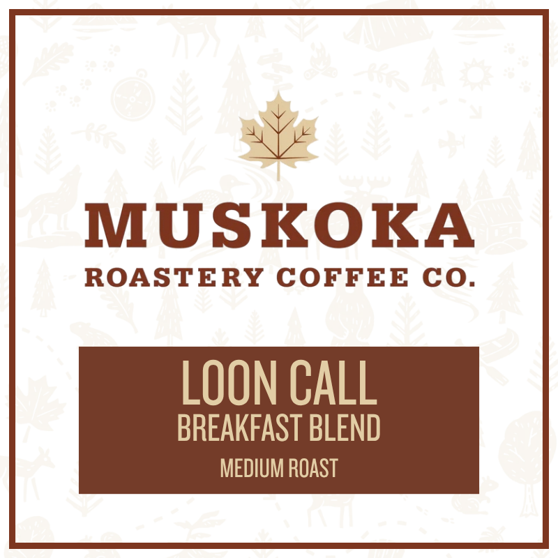 A square coffee label design for Muskoka Roastery Coffee Co. featuring a light cream background with faint winter tree illustrations, a gold maple leaf logo, and brown text reading 'MUSKOKA ROASTERY CO.