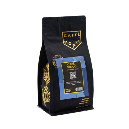 Caffè Monte coffee bag with gold floral accents on a white background