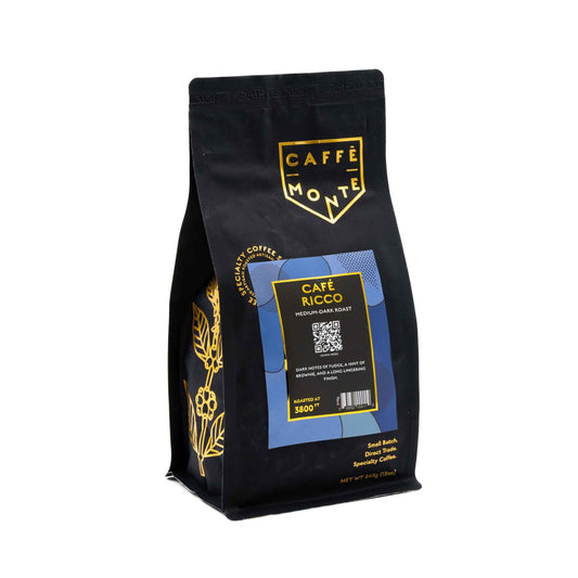 Caffè Monte coffee bag with gold floral accents on a white background